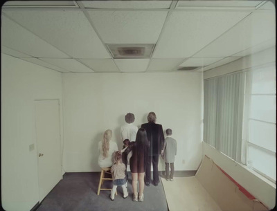 a group of people standing in an empty room