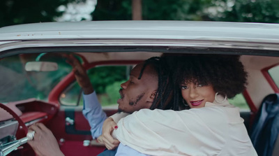 a man and a woman sitting in a car