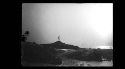 a black and white photo of a person standing on a hill