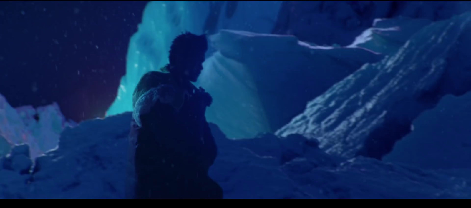 a man standing in the snow in front of ice formations