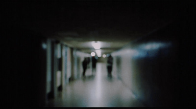 a long hallway with people walking down it