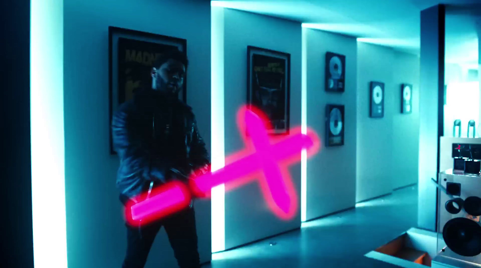 a man standing in a hallway with a pink light