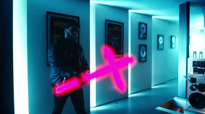 a man standing in a hallway with a pink light