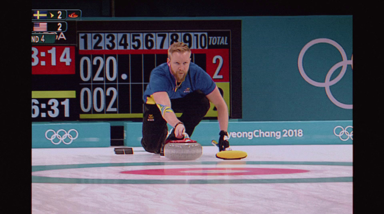 a man is curling on a curling rink