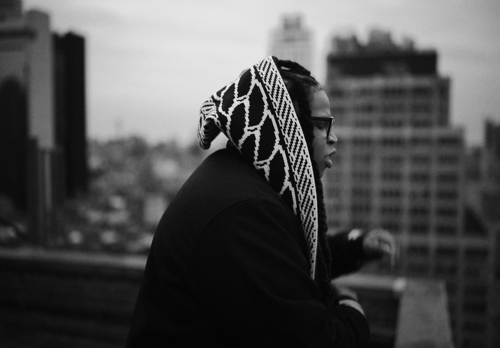 a black and white photo of a person wearing a scarf