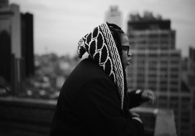 a black and white photo of a person wearing a scarf