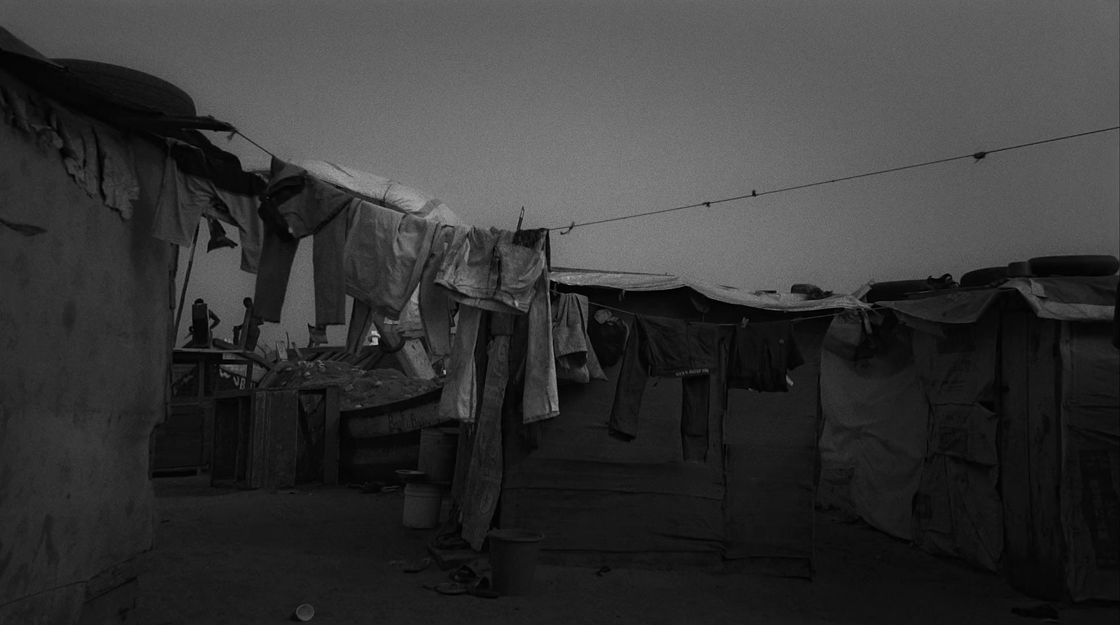 a black and white photo of clothes hanging on a line