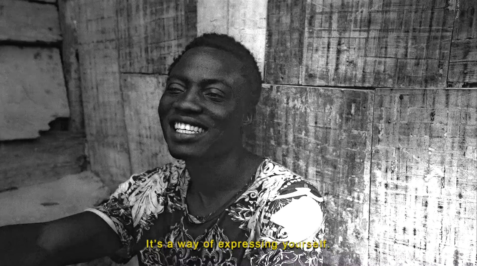 a black and white photo of a smiling man