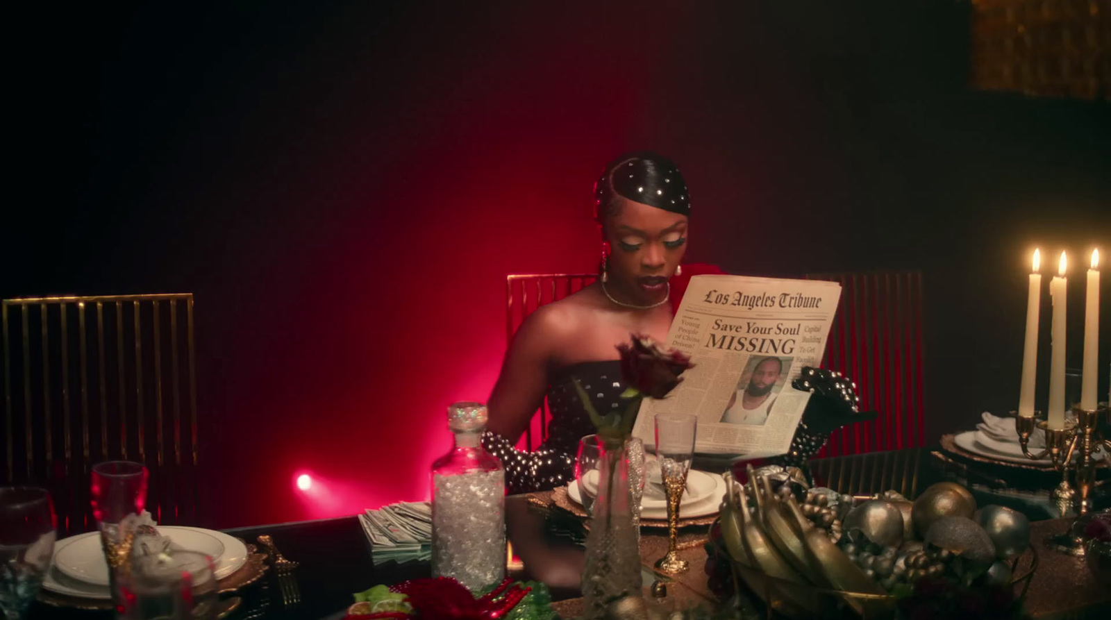 a man sitting at a table reading a newspaper