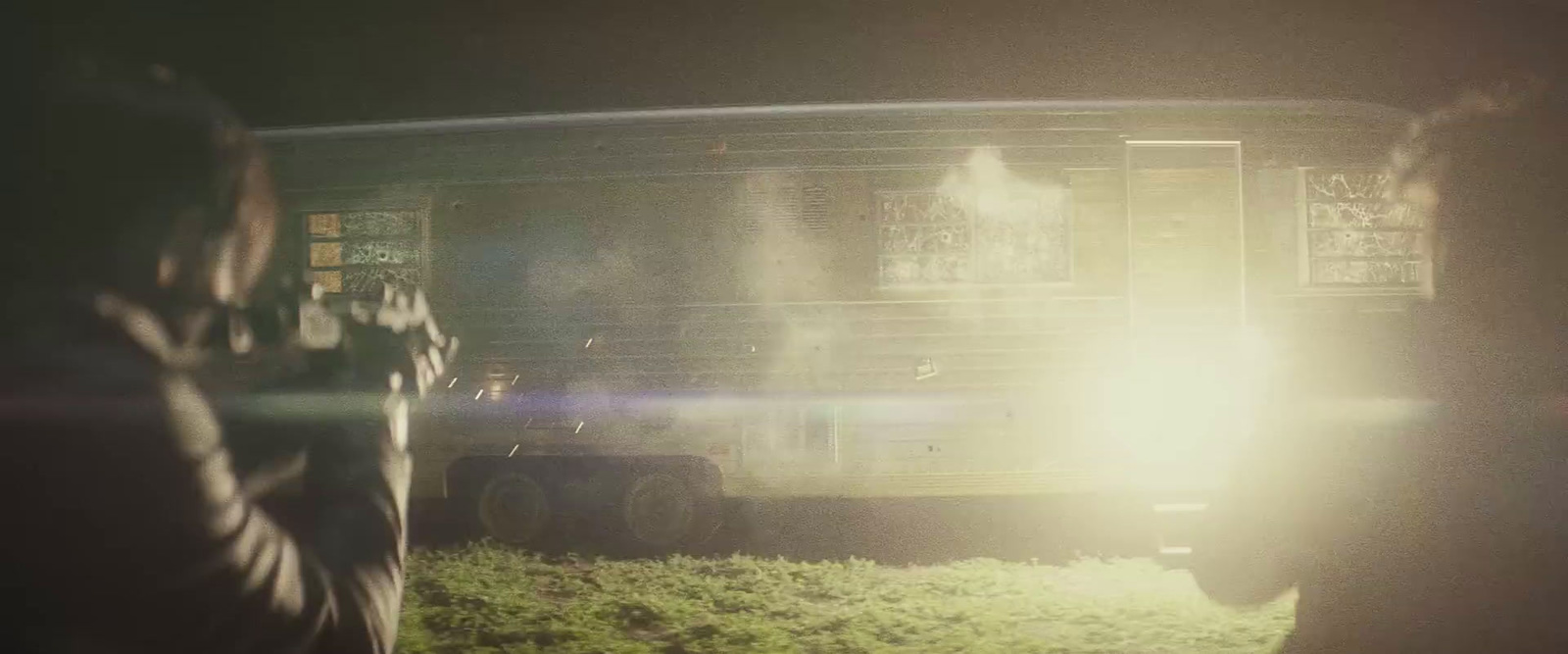 two people standing in front of a bus at night