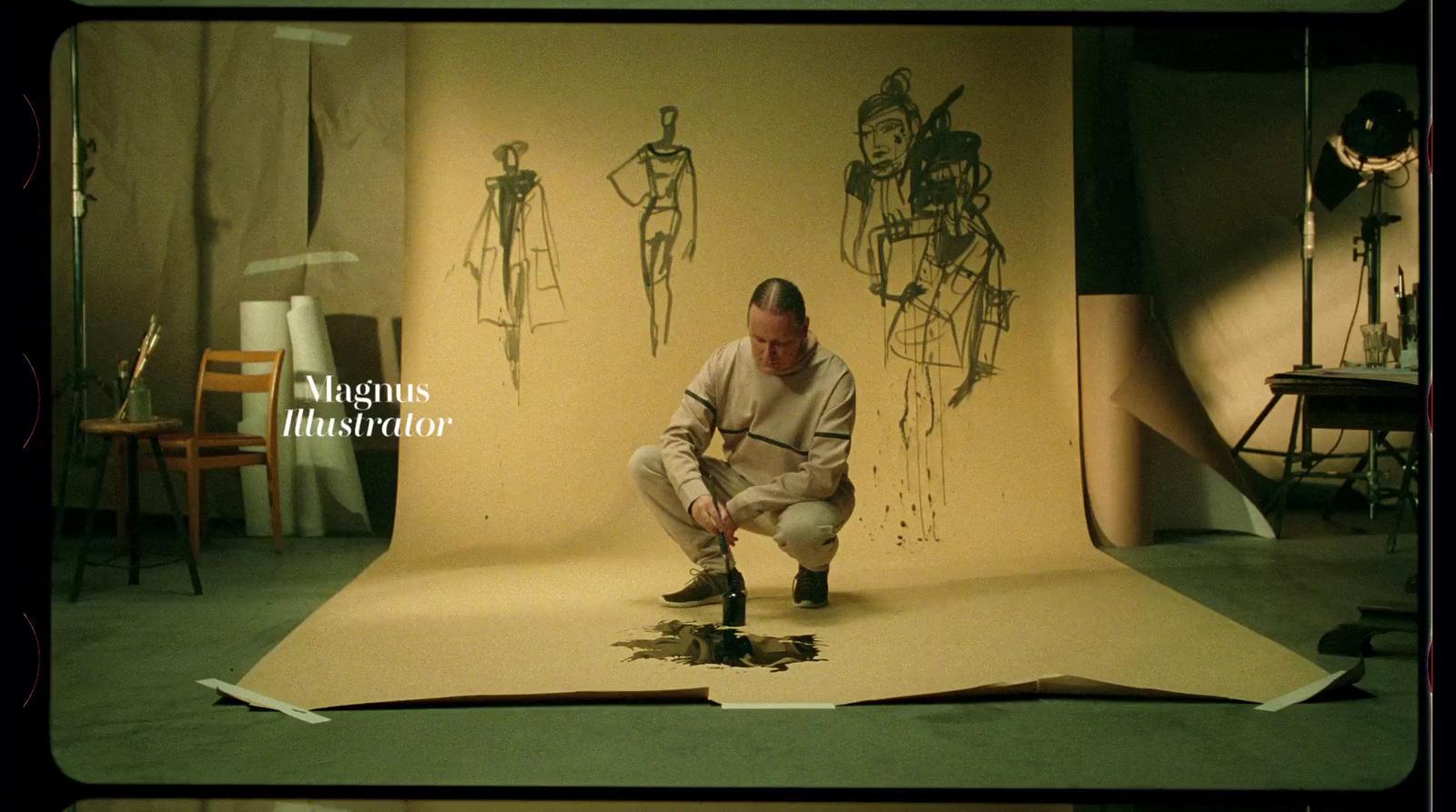 a man kneeling down in front of a drawing