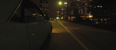 a car driving down a city street at night