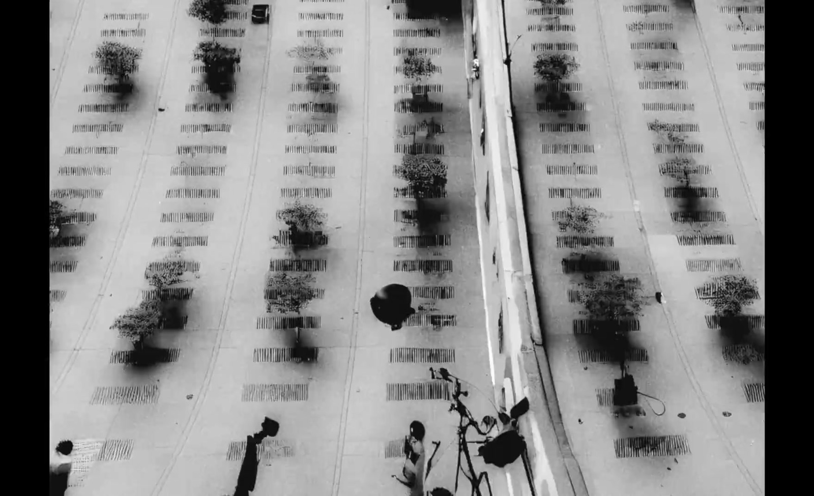 a black and white photo of a bike parked in a parking lot