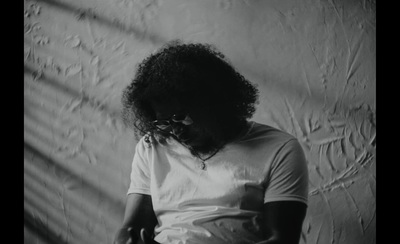 a black and white photo of a woman with curly hair