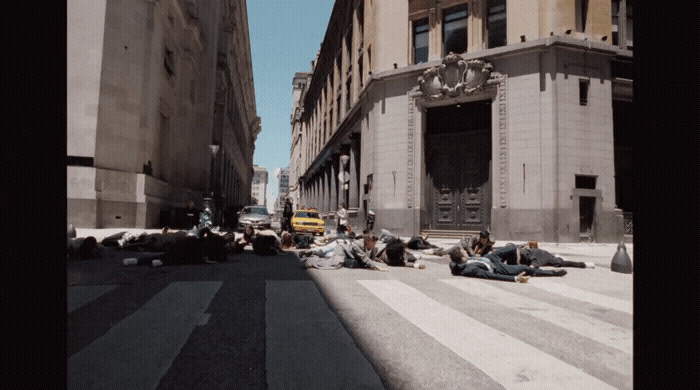 a group of people laying on the side of a road