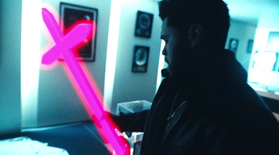 a man standing in a room with a neon stick in his hand