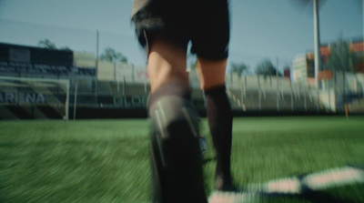 a person standing on top of a lush green field