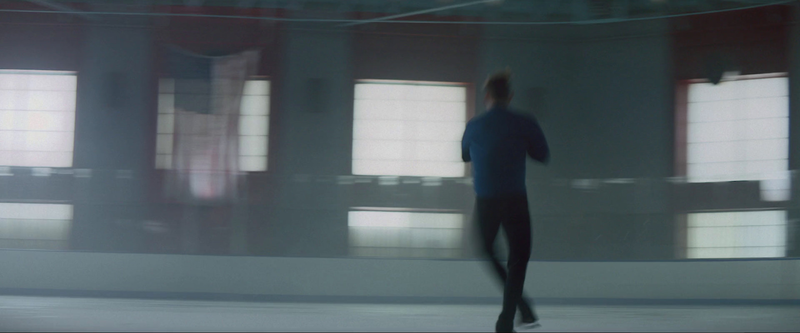 a blurry photo of a person skating on a rink