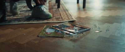 a picture of a person sitting on the floor next to a pair of scissors