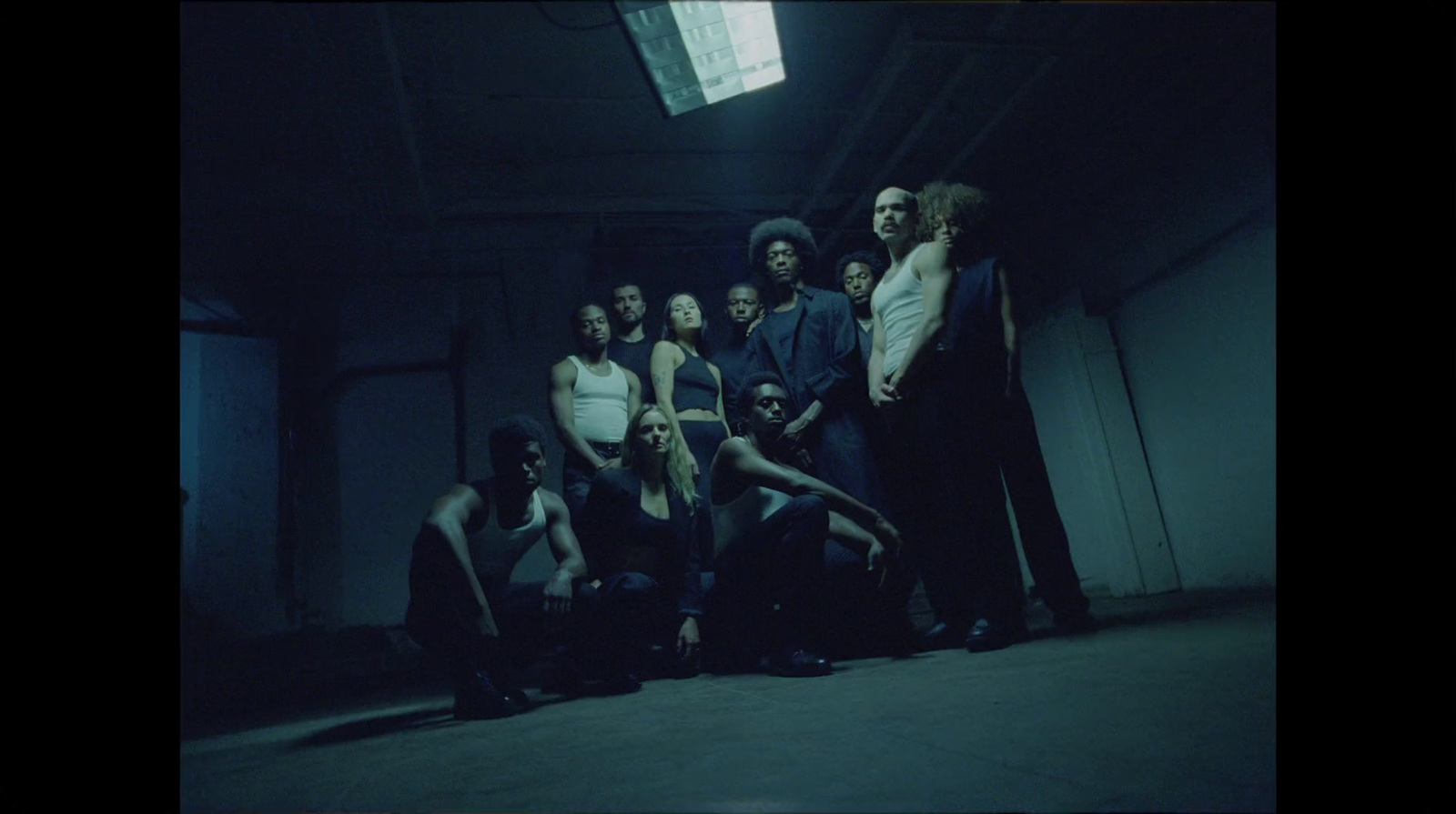 a group of people standing in a dark room