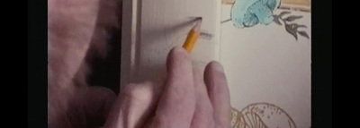 a person writing on a book with a pencil