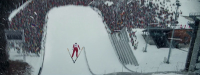 a snow covered ski slope in front of a crowd of people