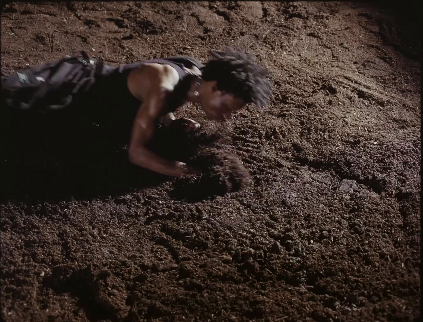 a man laying on top of a pile of dirt