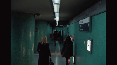 a couple of women walking down a hallway