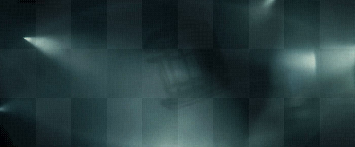 a blurry photo of a chair in a dark room