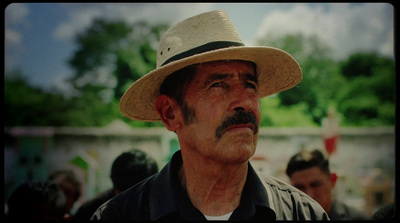 a man with a mustache wearing a hat