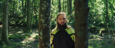 a man standing in the middle of a forest