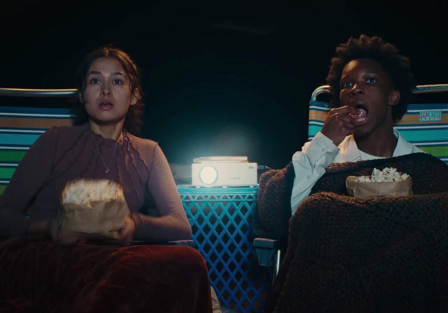 a couple of people sitting next to each other