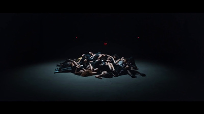 a group of people laying on the ground in the dark