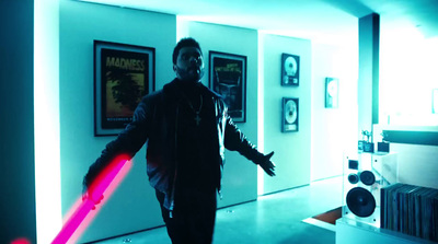 a man holding a red light saber in a room