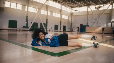 a woman laying on the floor in a gym