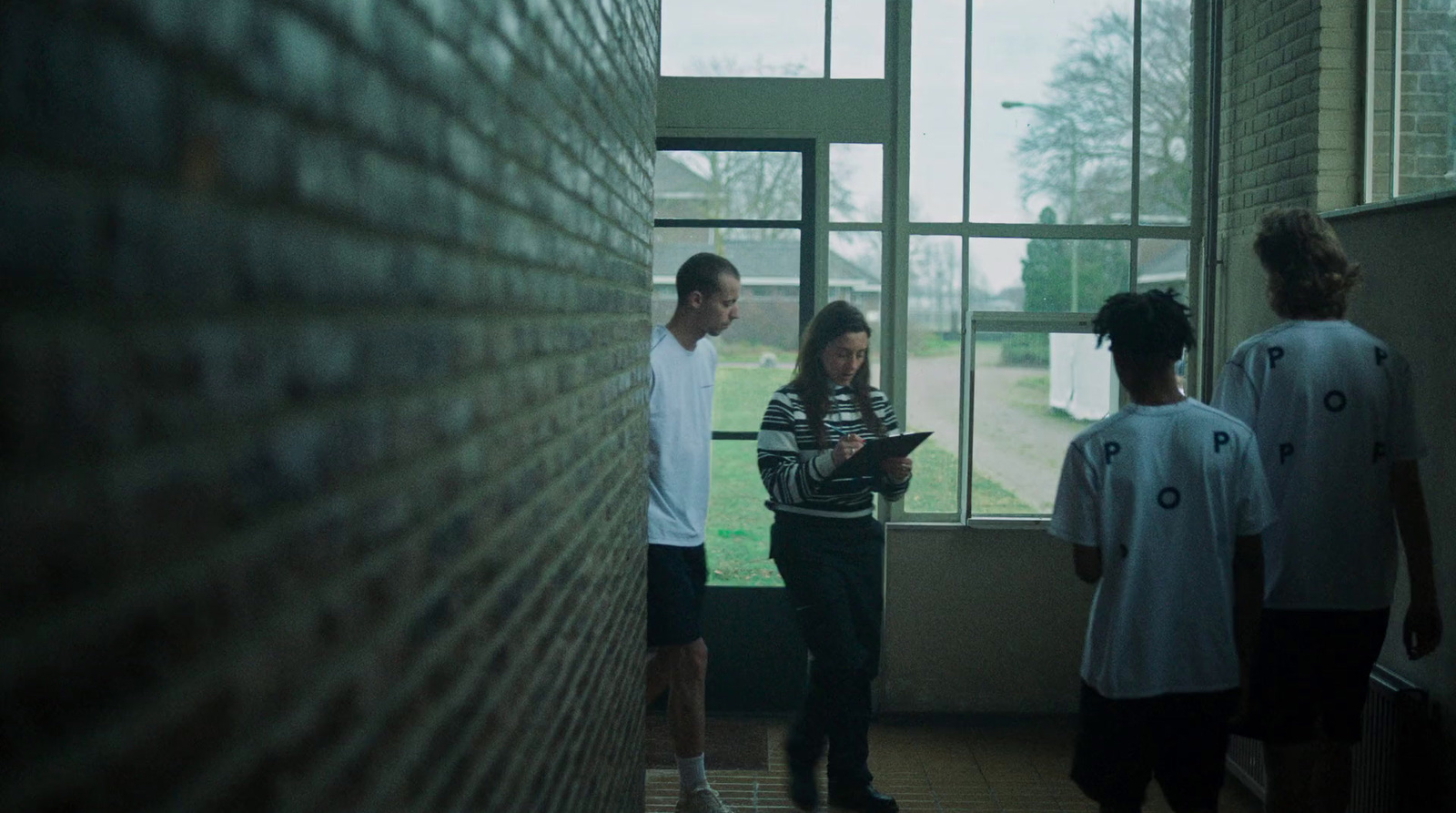 a group of people standing in front of a window