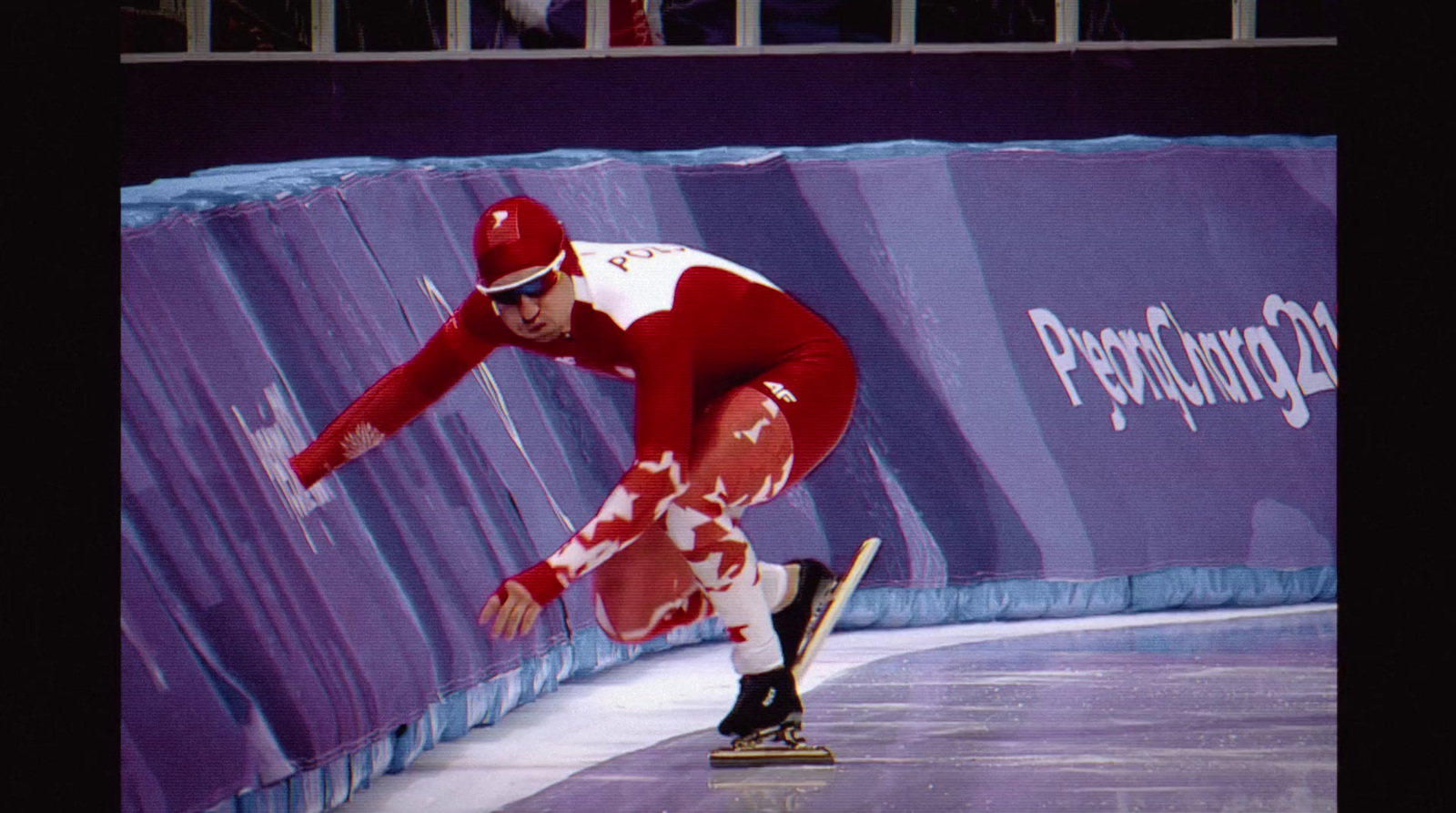 a man riding a skateboard down a snow covered slope