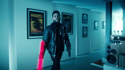 a man walking down a hallway holding a red object