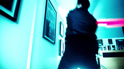 a person standing in a room with a clock on the wall