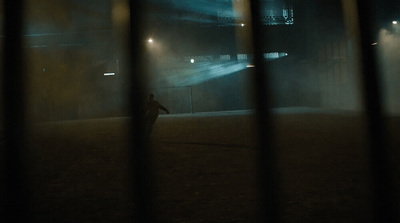 a person standing in a field at night