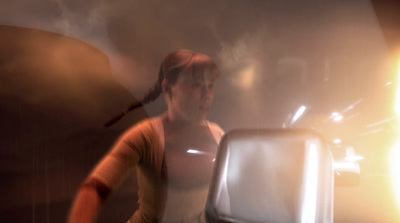 a blurry image of a woman standing in front of a mirror