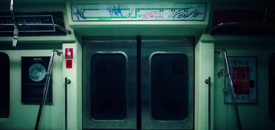 the doors of a subway car with graffiti on it