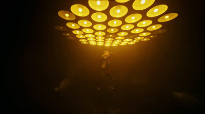 a person standing under a lit up light fixture