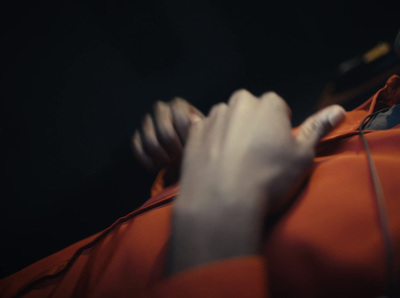 a close up of a person wearing an orange jacket