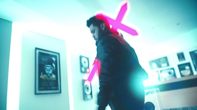 a man in a room with a neon cross on his head