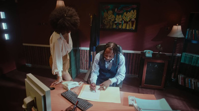 a man sitting at a desk in front of a monitor