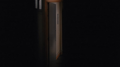 an open door in a dark room with a clock on it