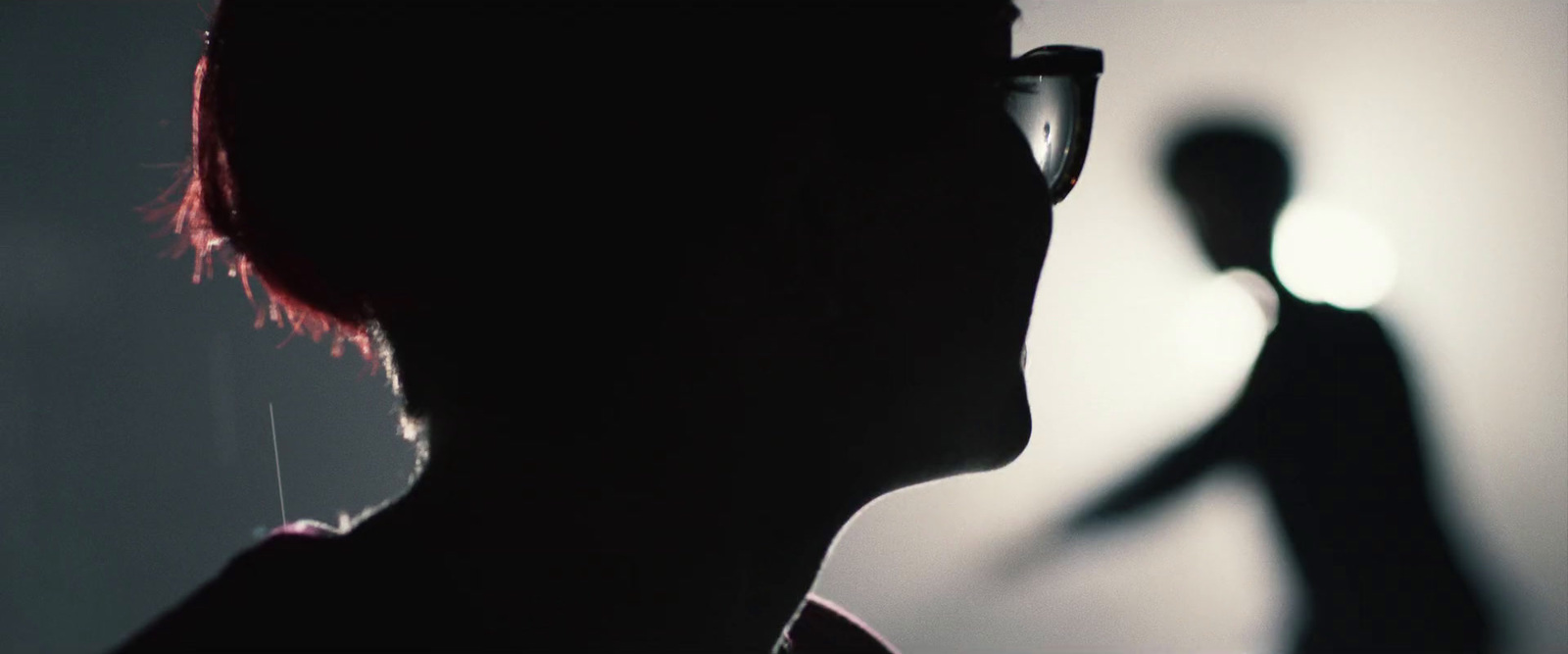 a silhouette of a person with a pair of glasses