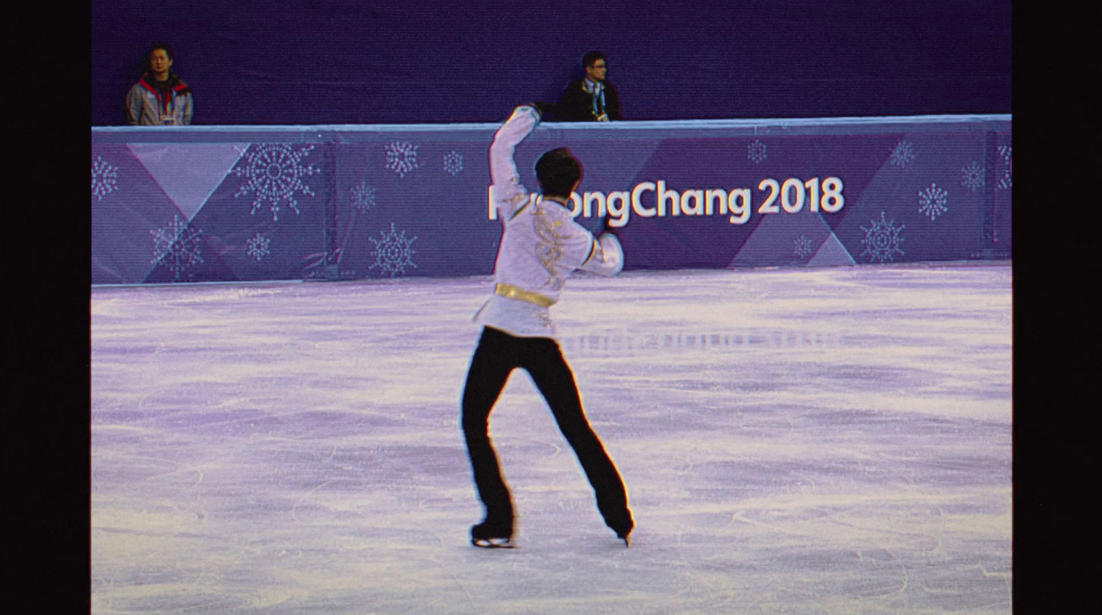 a man is skating on an ice rink