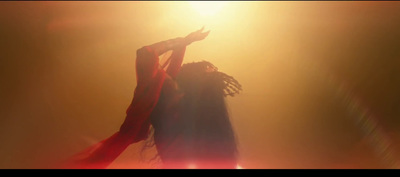 a woman with dreadlocks standing in front of a light